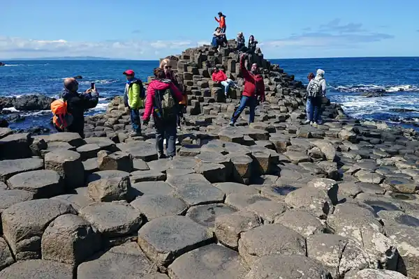 Visitors exploring the basalt columns on our Giants Causeway Tour Private Belfast Tours