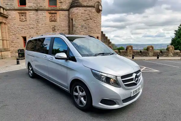 Luxury Mercedes vehicle providing Airport Transfers Belfast service outside Belfast Castle