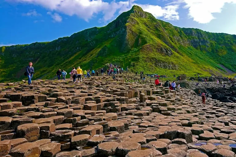 Visitors walking across the basalt columns at the Giant’s Causeway