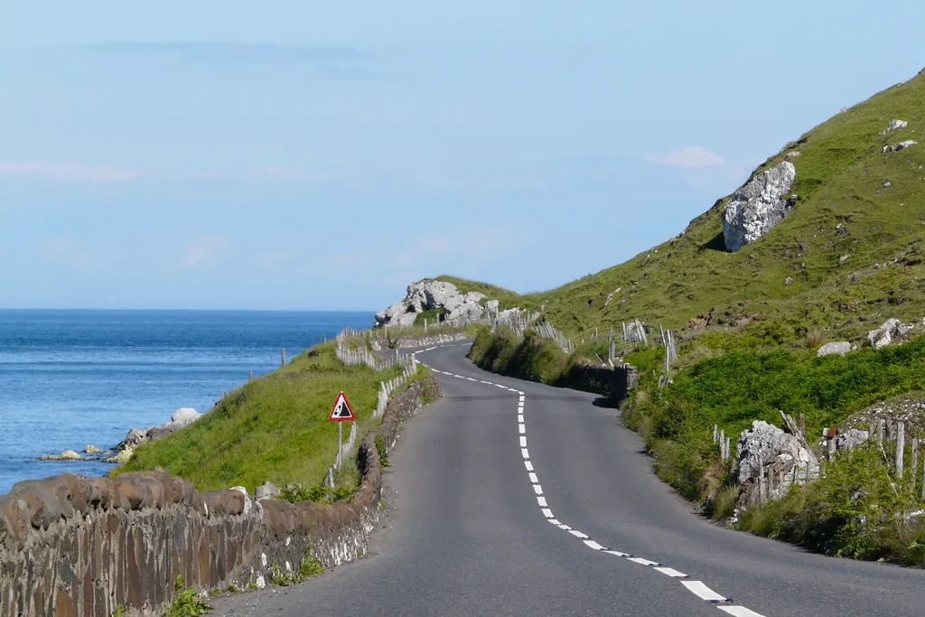 The Antrim Coast Road curving between the sea and the cliffs on the County Antrim coast