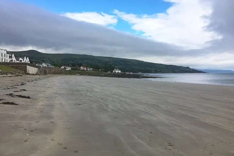 Ballygally beach on the Antrim Coast with Ballygally Castle above the shore