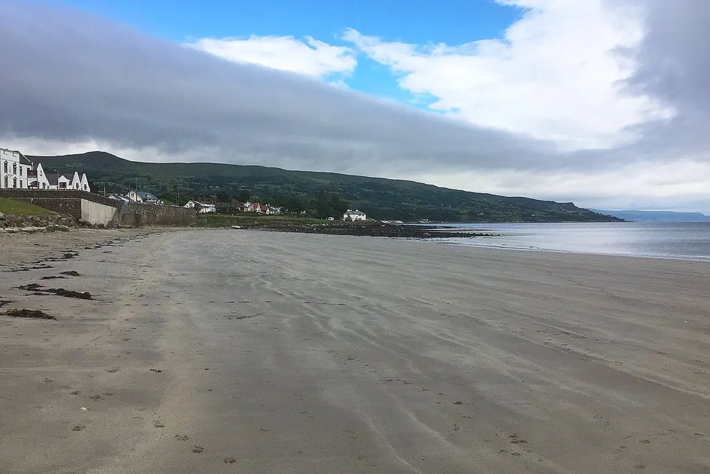 Ballygally beach on the Antrim Coast with Ballygally Castle above the shore