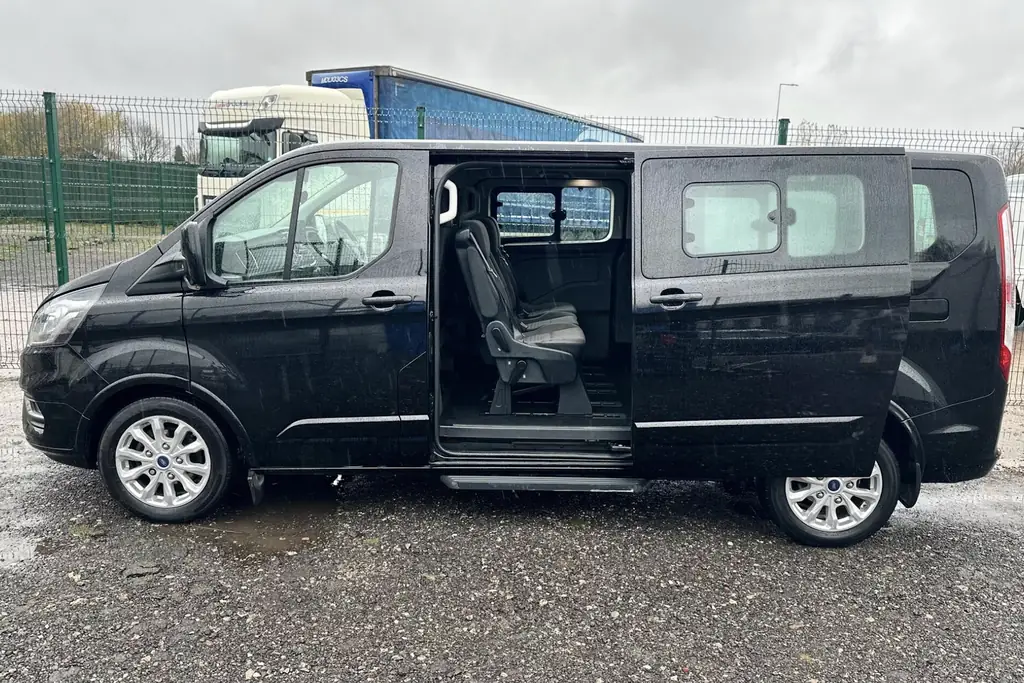 Ford Tourneo Custom with the side door open, used for Belfast airport transfers