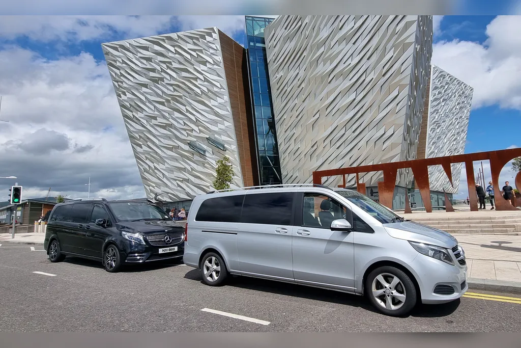 Two Belfast Tours NI Mercedes-Benz V-Class vehicles outside Titanic Belfast in the Titanic Quarter