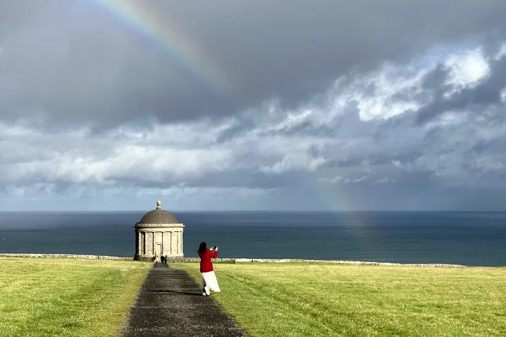 A rainbow over Mussenden Temple on the cliff edge at Downhill Demesne, overlooking the North Atlantic on Northern Ireland's Causeway Coast