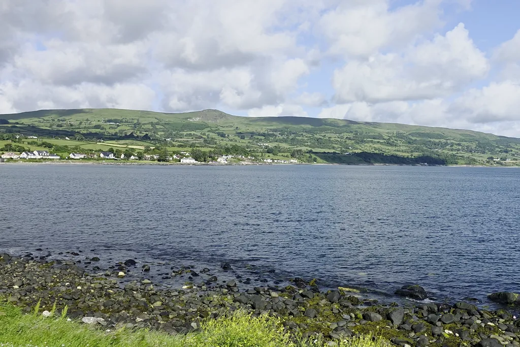 Sallagh Braes rising above Ballygally village and bay on the Antrim coast, near Cairncastle