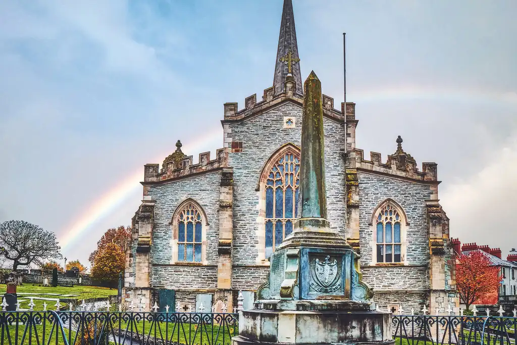 St Columb’s Cathedral in Derry with rainbow in the background