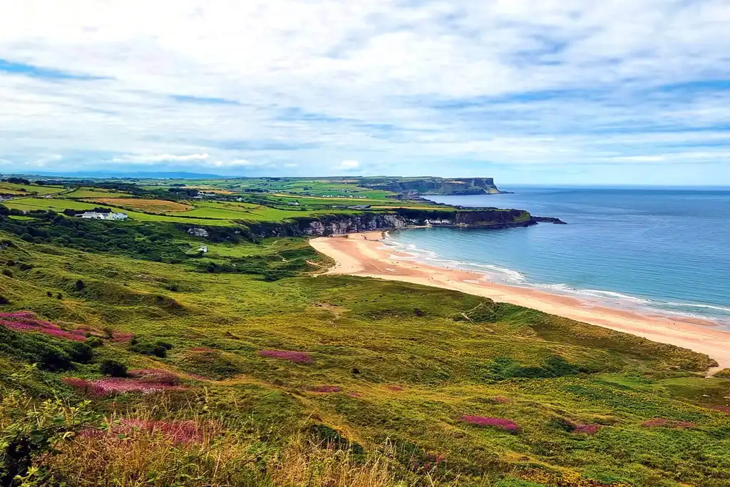 Whitepark Bay on the Causeway Coast in Northern Ireland with sandy beach and dramatic cliffs