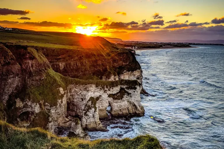 The limestone cliffs at Whiterocks near Portrush with the sun setting over the sea